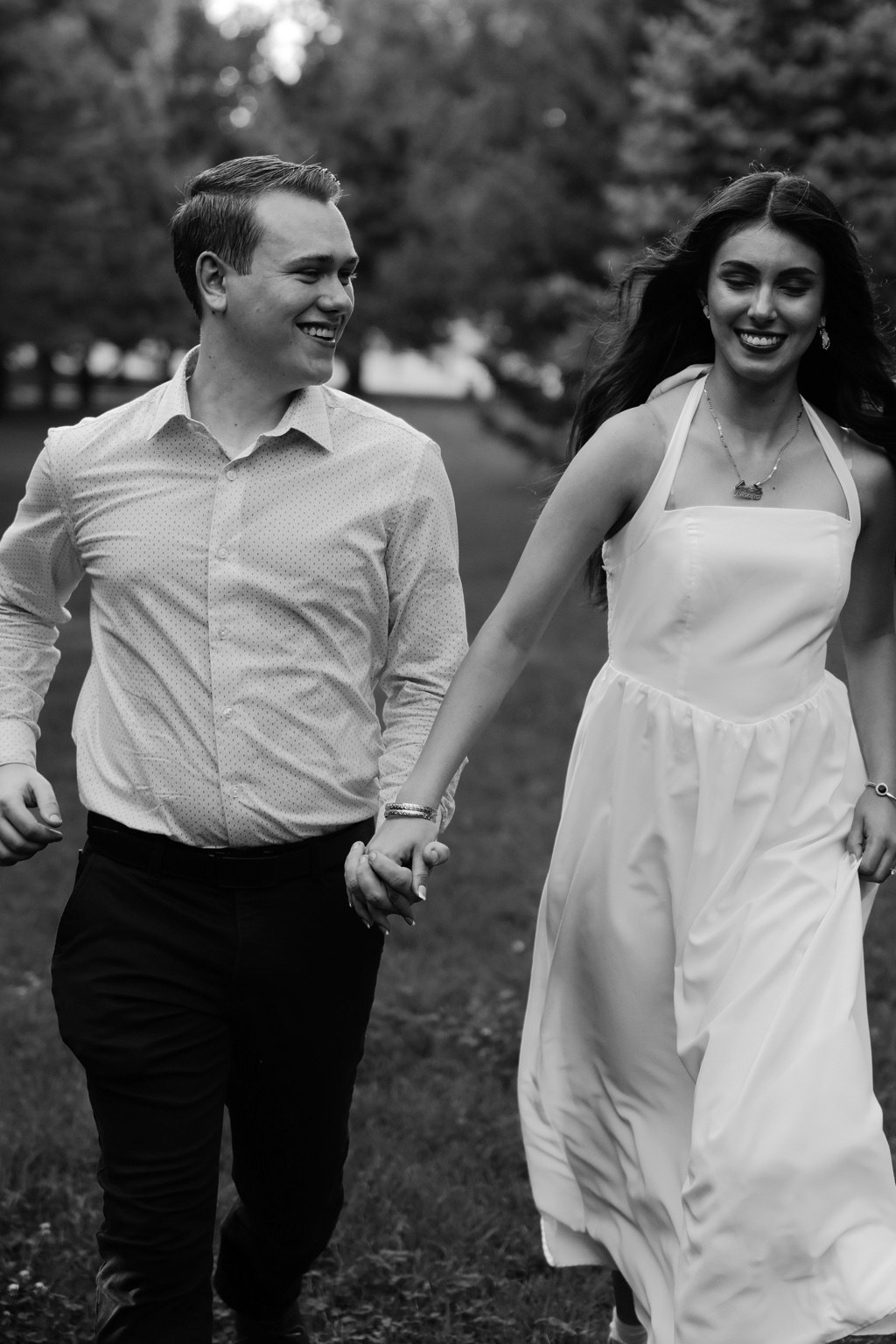 Black and white photograph of a couple walking hand in hand