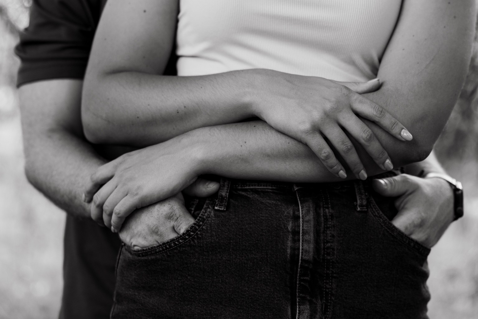 Black and white detail of a couple holding each other
