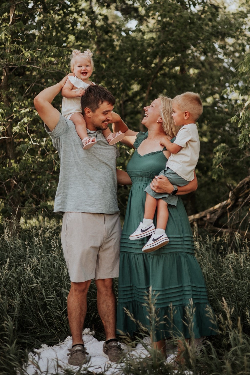 Parents holding their two children