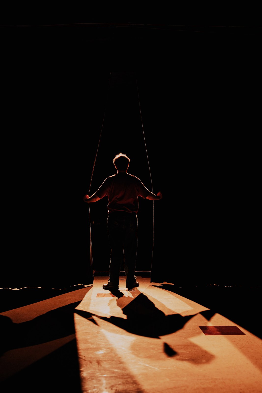 Dramatic stage portrait of a senior holding jump ropes