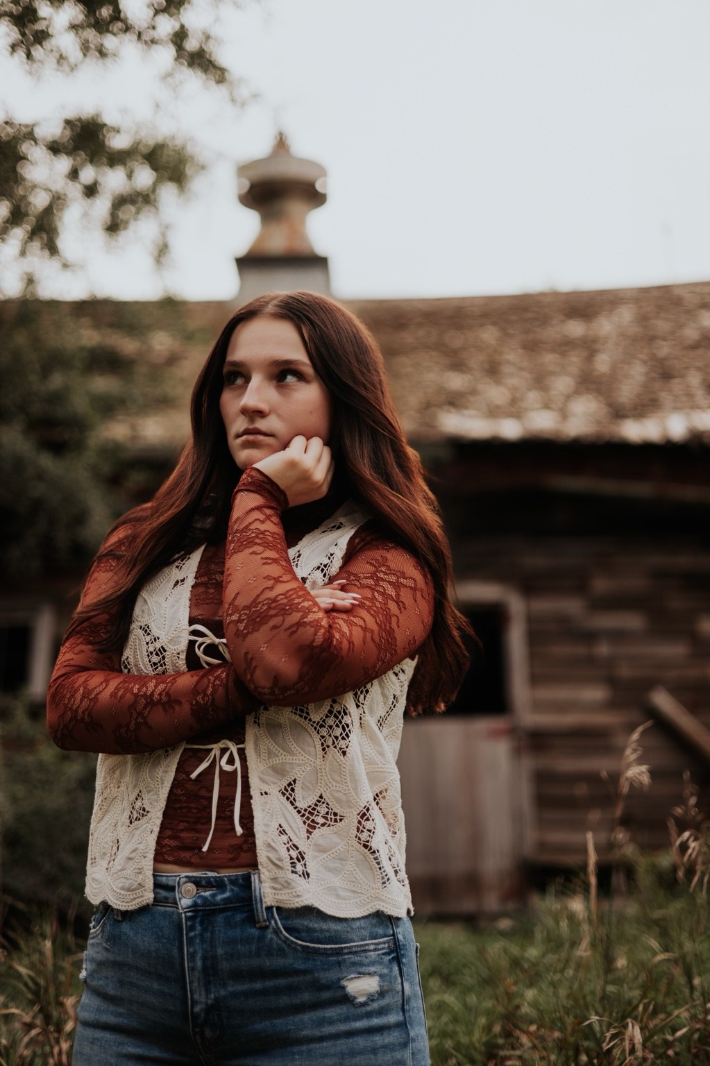 Western senior portrait beside weathered wood