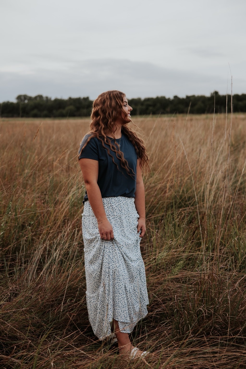 Senior in a long skirt in prairie grass