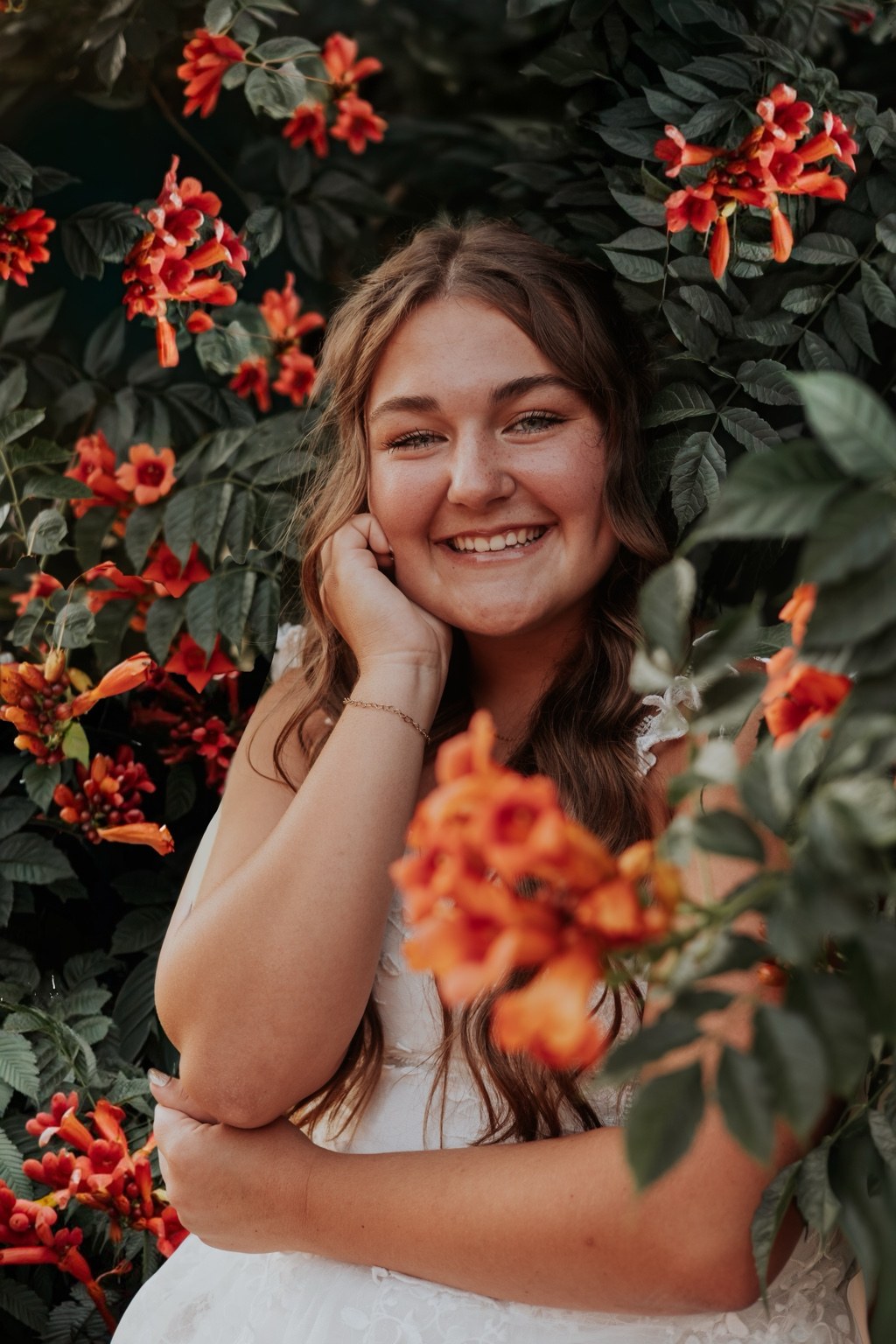 Senior smiling among flowers