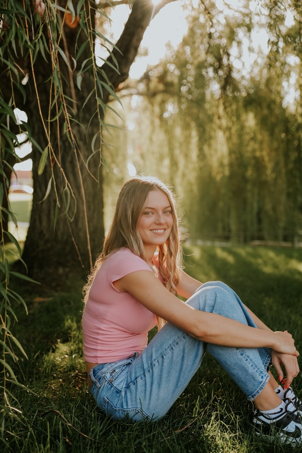 Senior sitting beneath willow branches