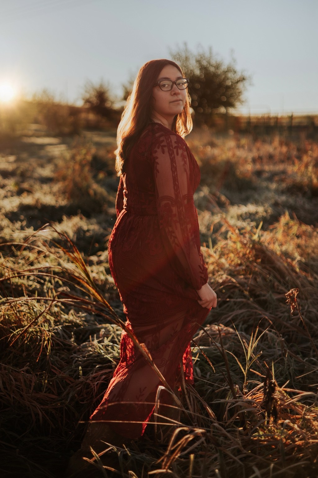 Senior in warm light in tall grass