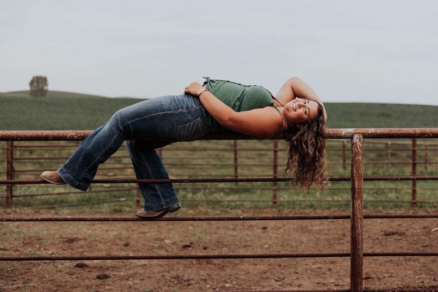 Senior reclining across a country gate