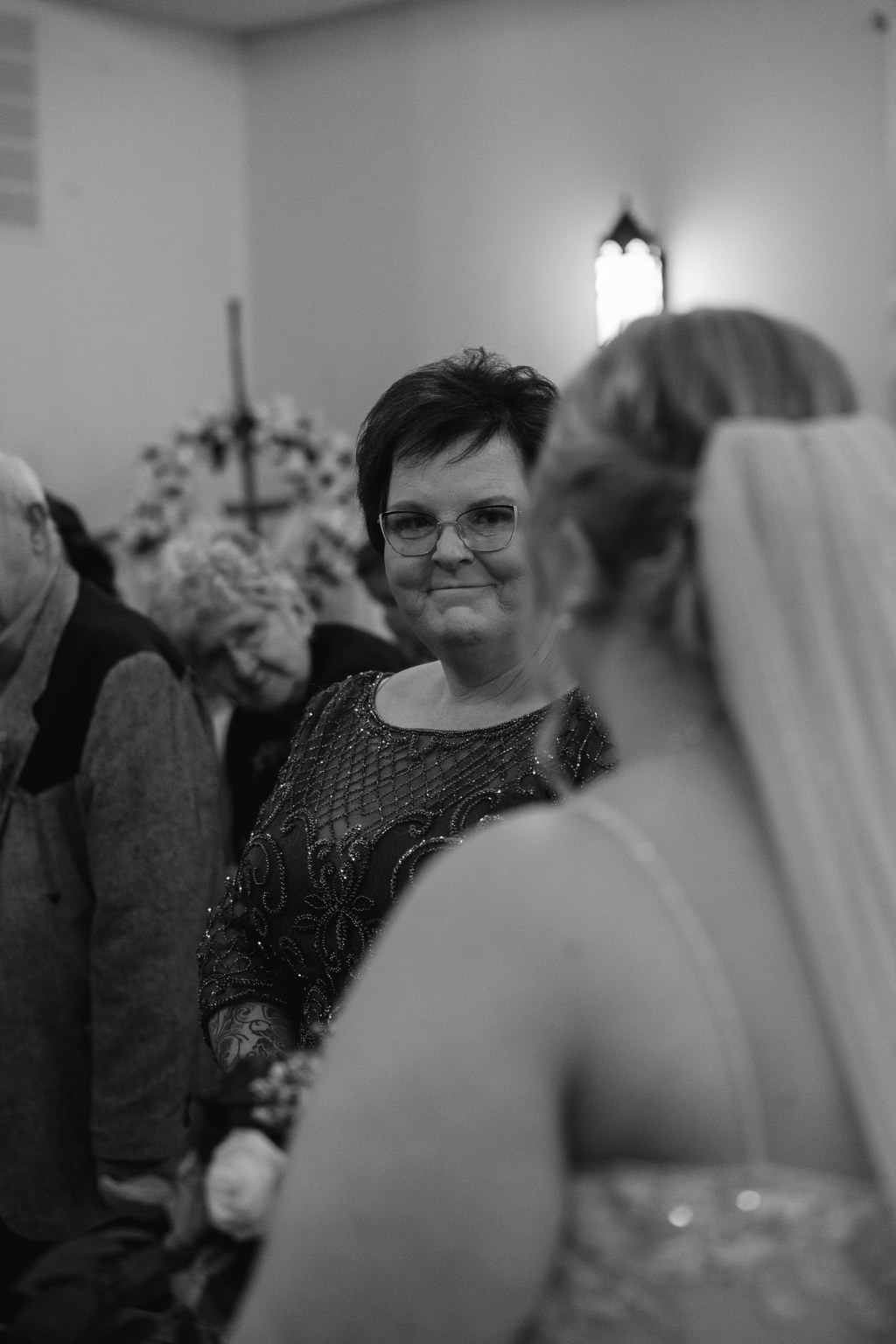 A wedding guest watching the bride during the ceremony